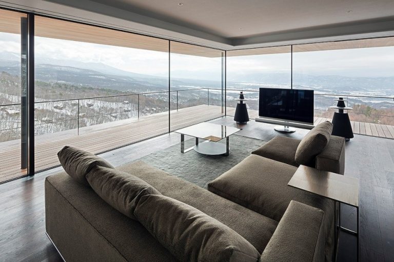 Vidraçaria Big Vidros - uma imagem em uma sala contendo um sofá, tv e no fundo uma parede de vidro